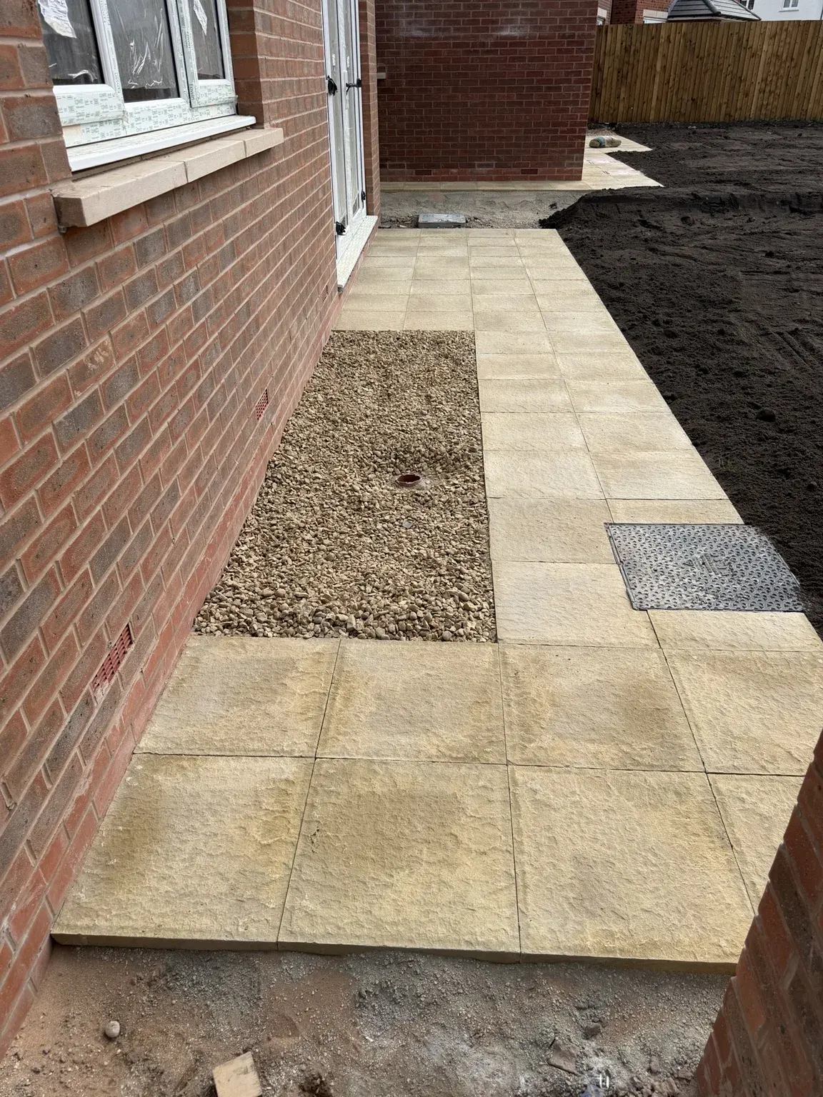 Finished paving and gravel strip beside a home in Congleton