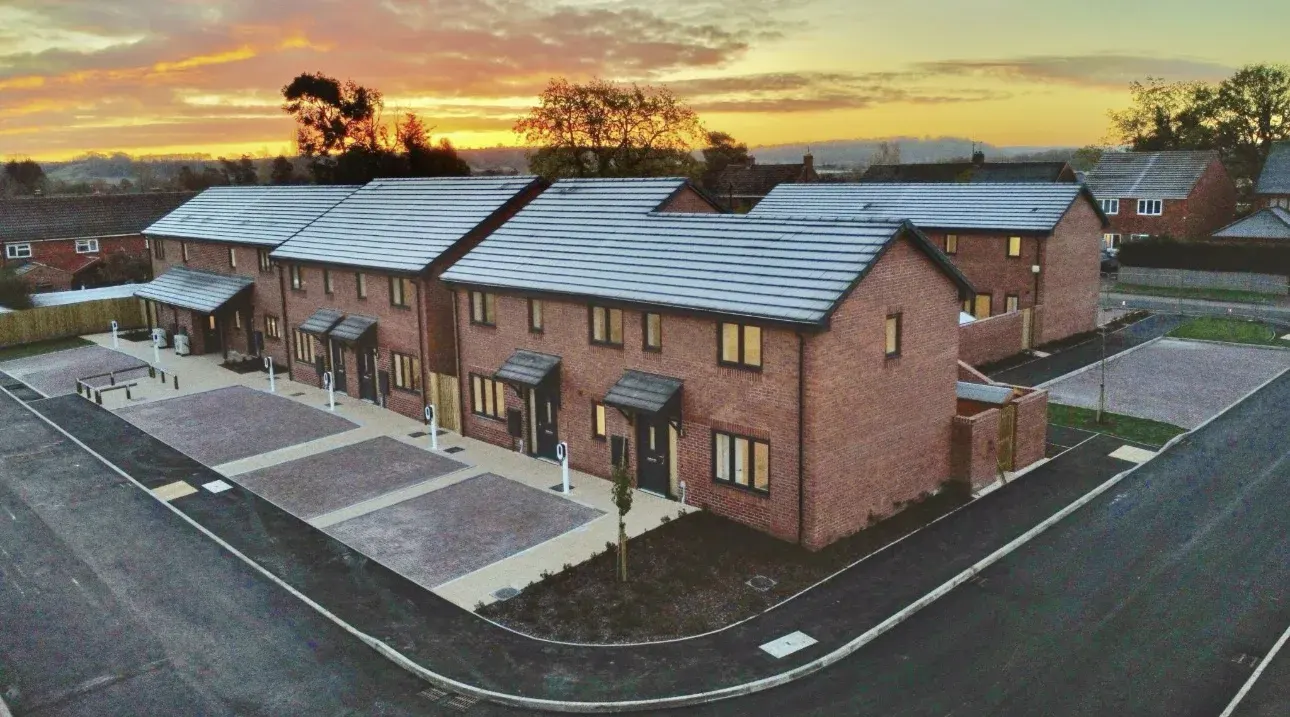 Completed Johnstone Close development with roads, driveways and paths at sunset